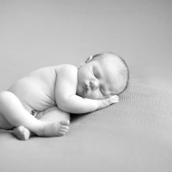 B&W newborn image of a sleeping baby