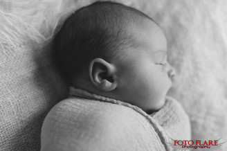 Photograph of a newborn swaddled and sleeping