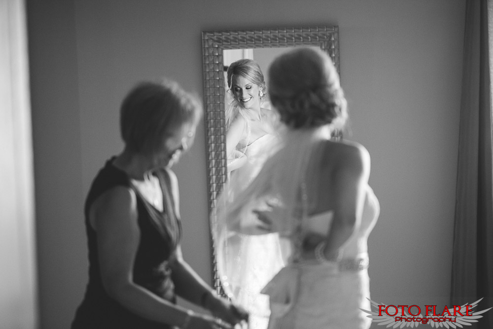 reflection of mom helping bride