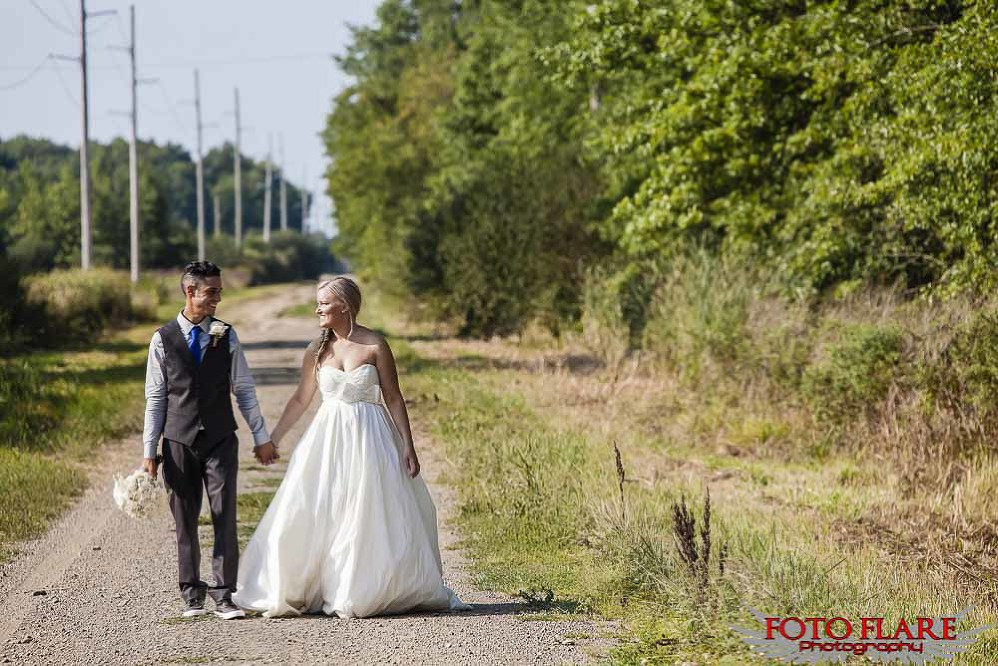 bride and groom walking on dirt road