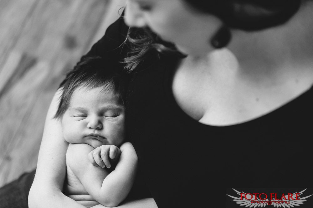 mother holding sleeping baby