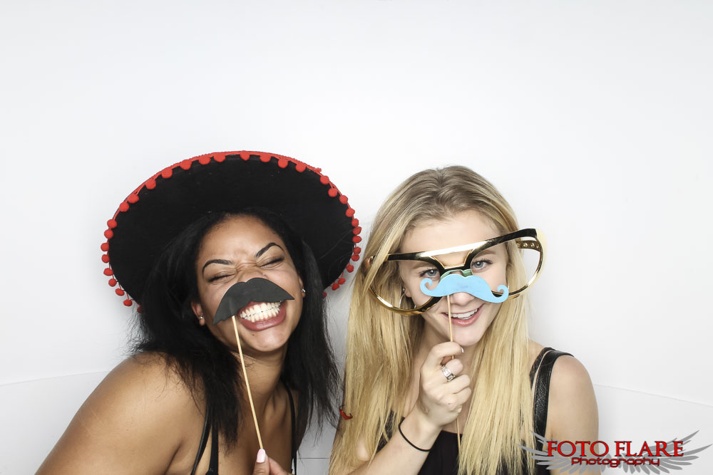 two girls using silly photo booth props