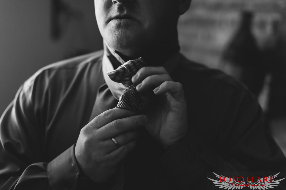 B&W image of Dalton tying the tie