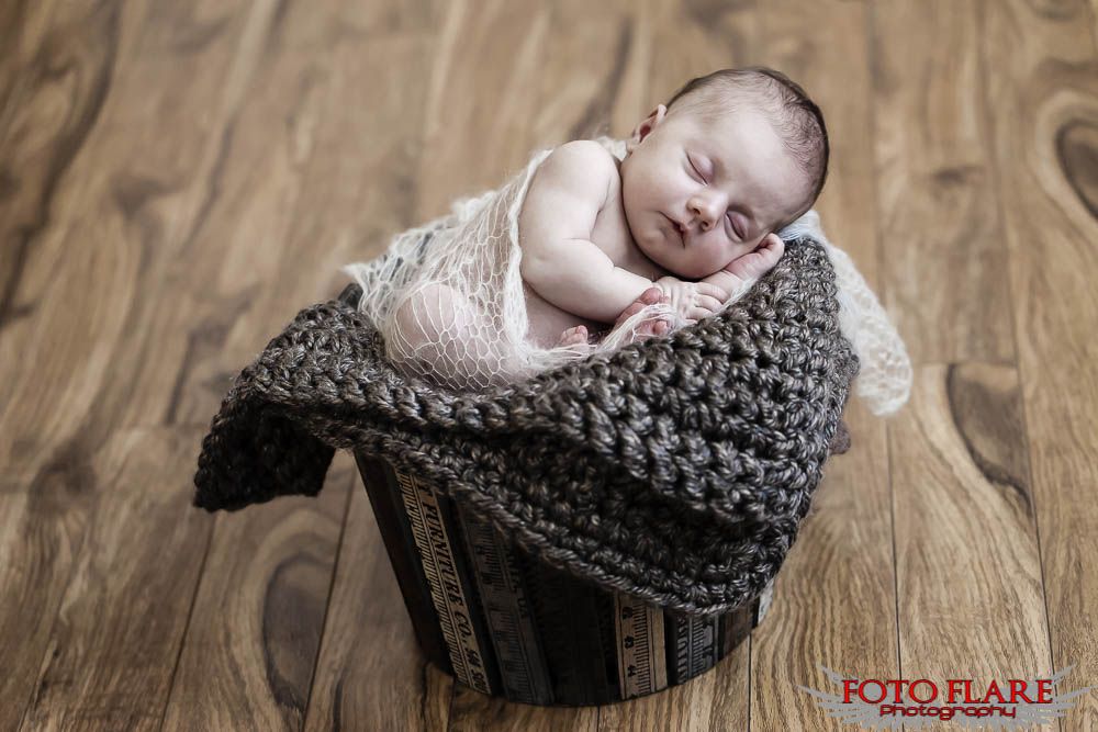 newborn photo of baby in wooden basket