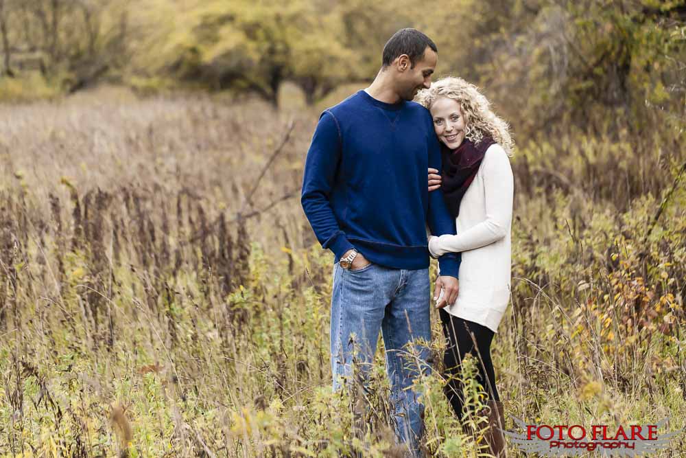 Couple standing in a field in the fall
