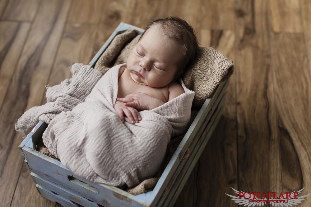 Cute newborn sleeping in a basket
