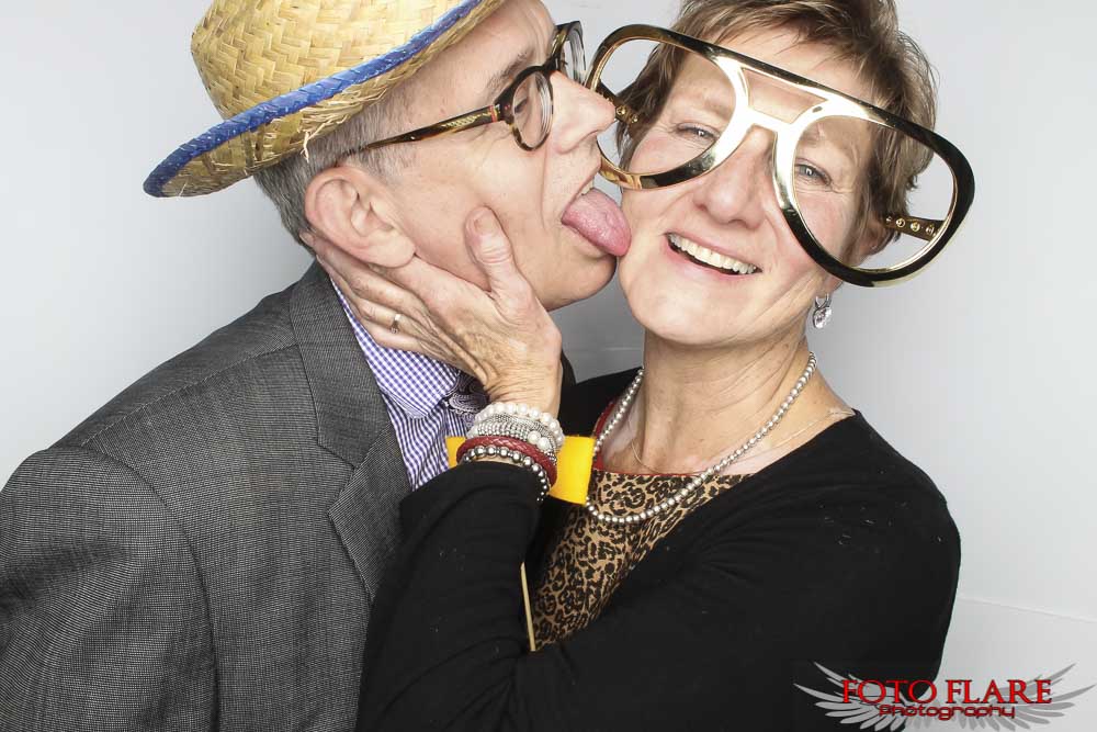 old people having fun in a photo booth