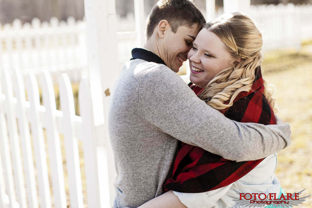 Engagement photos with white picket fence