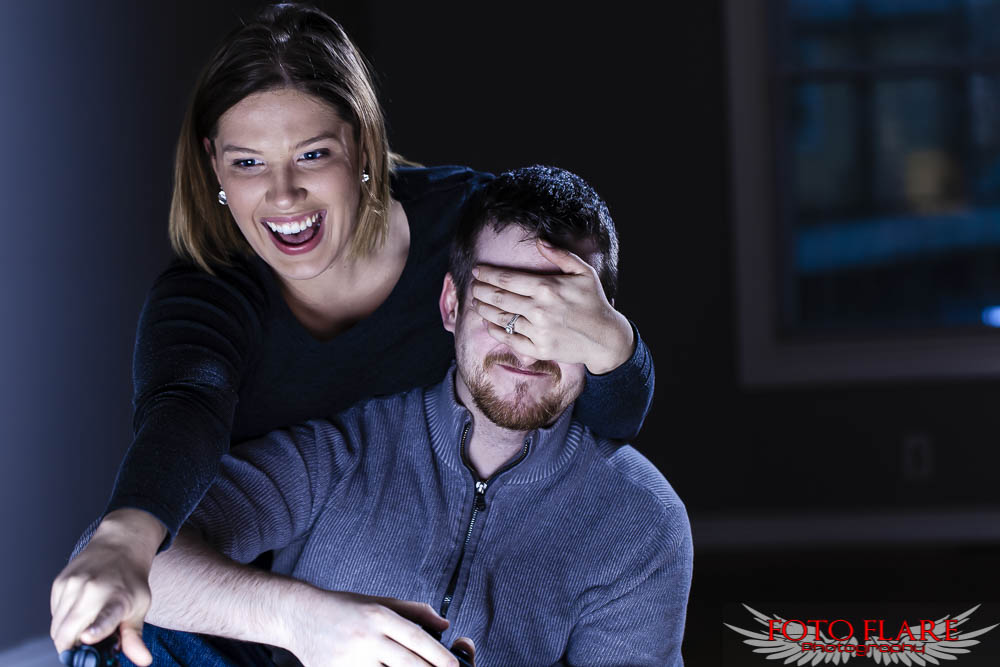 Engagement photos of couple playing video games