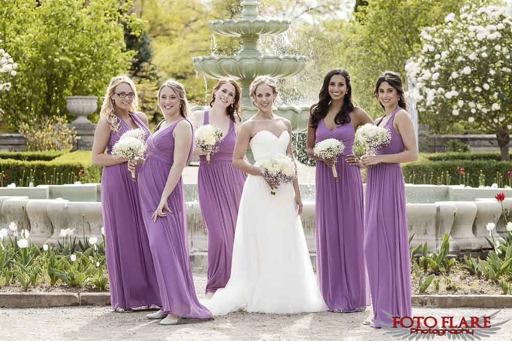 The bridesmaids in front of the water fountain