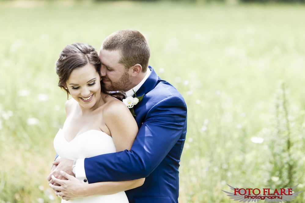 Outdoor wedding image of couple hugging