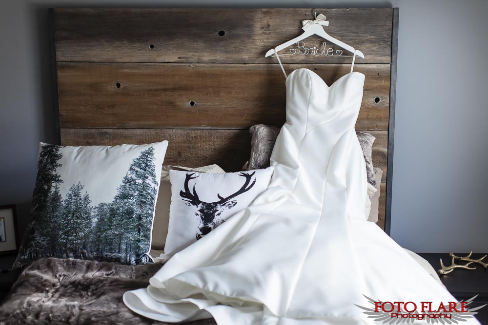 wedding dress on rustic bed