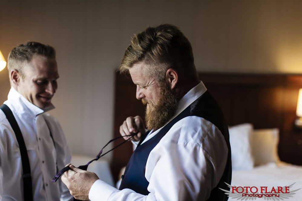 Best man helping with tie