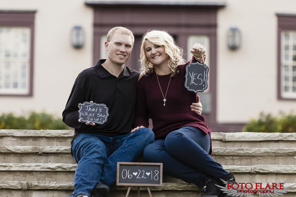 Couple holding signs for wedding date