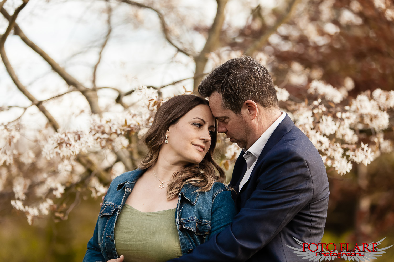 Engagement photo of a couple with cherry blossoms